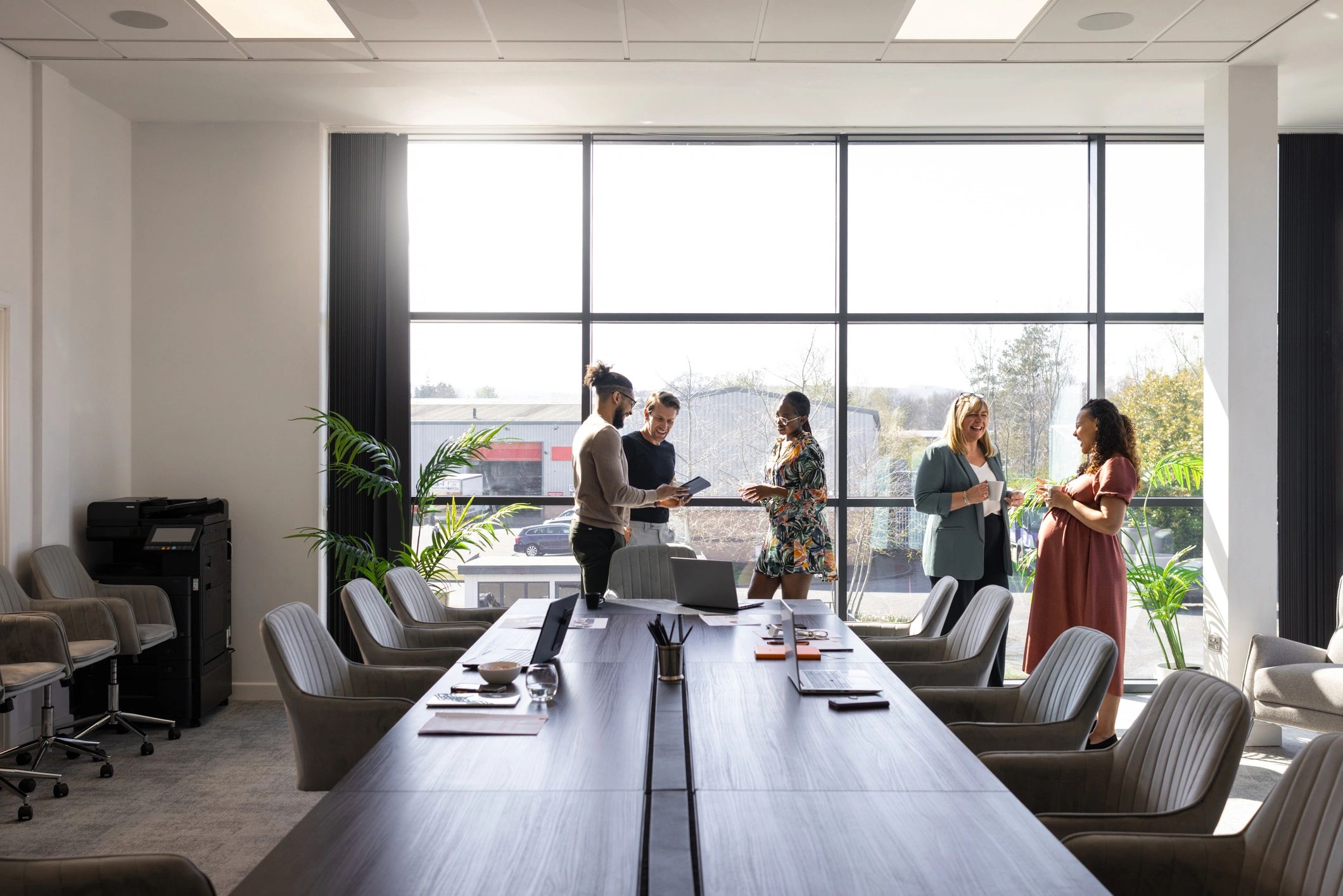Executives in a modern boardroom meeting discussing strategy