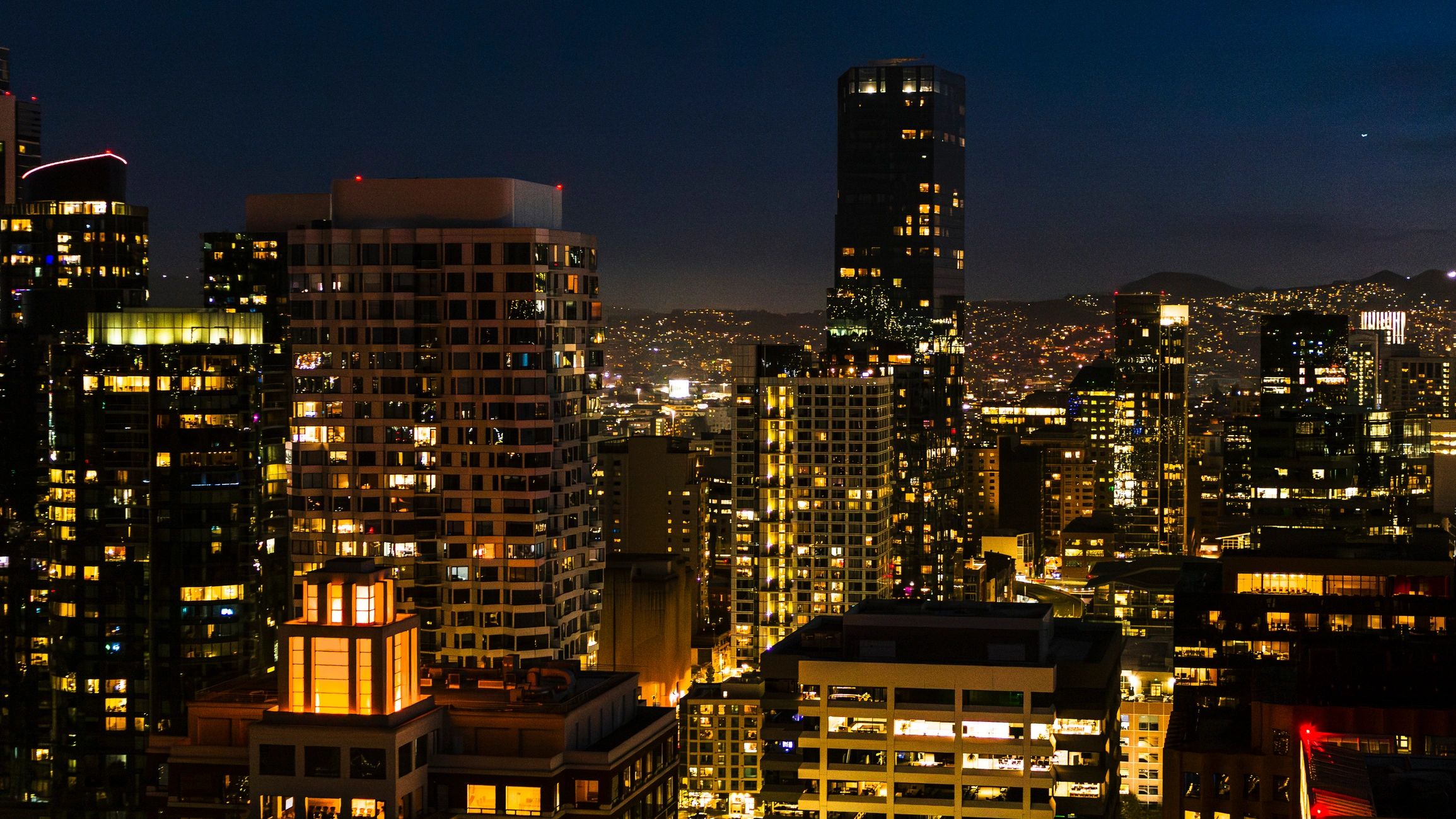 Illuminated downtown skyline representing financial partnership and long-term capital